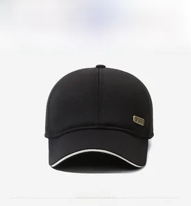Close-up of black corduroy baseball cap with a gold SPORT metal logo and white sandwich brim