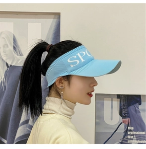 Detail of light blue knitted sun visor hat featuring white SPORT embroidery on brim