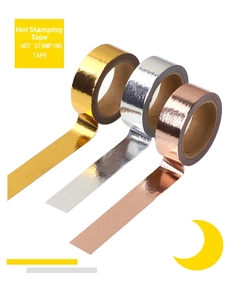 Three rolls of shiny metallic hot stamping tape in gold, silver, and rose gold finishes