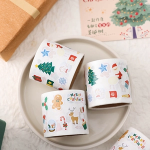 Close-up of Christmas sticker rolls with Santa, reindeer, and festive holiday patterns