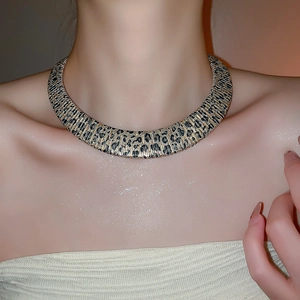 Close-up of wide leopard print choker featuring vintage wild patterns and metallic texture