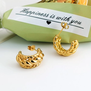 Chic twisted gold-plated U-shaped earrings with braided texture on a white gift background