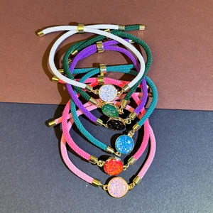 Adjustable woven rope bracelets with colorful glitter pendants and golden metal accents
