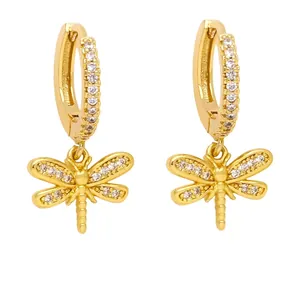 Elegant gold dragonfly earrings with micro-set zircon crystals on white background