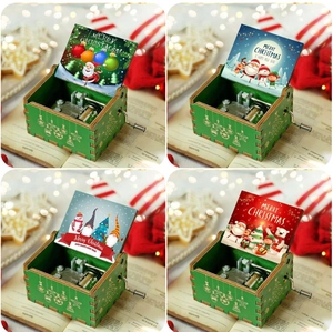 Detail view of colorful hand-cranked wooden music boxes with festive Christmas illustrations