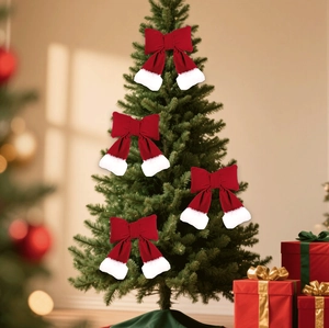 Set of four red and white velvet bows hanging on a Christmas tree for holiday decoration