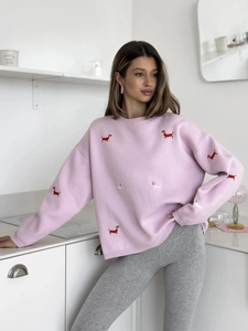Close-up of cute dachshund embroidery on pink knit sweater with round neckline