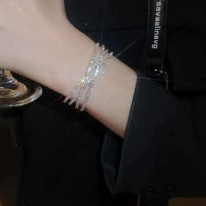 Close-up of luxury crisscross multi-layer silver bracelet with sparkling pavé rhinestones