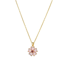 Detail of pink cherry blossom cat eye stone pendant on golden titanium necklace