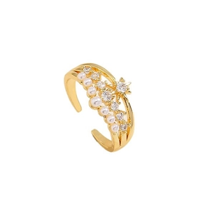Gold adjustable ring featuring elegant pearls and zircon evil eye accents on white backdrop