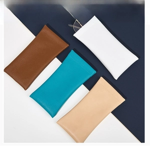 Physical display of leather glasses pouches in brown, white, blue and beige