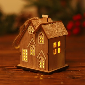 Lighted wooden Christmas house decoration with faux snow roof and warm LED glow