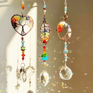 Three colorful Tree of Life suncatchers with crystal prisms and rainbow light effects