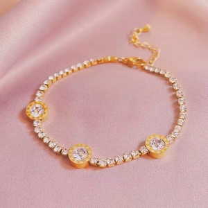 Elegant gold-plated bracelet with Roman numeral engraving and shimmering crystals on silk