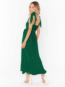 Detail of adjustable tie straps and smocked back on a dark green maxi dress