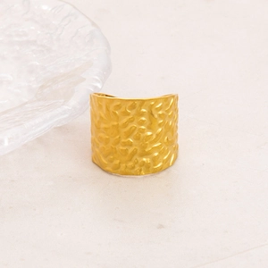 Macro detail of wide 18K gold plated stainless steel ring with hammered texture design