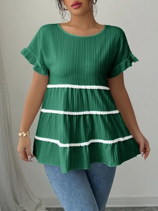 Detail of green pleated blouse with tiered lace trim and ruffled short sleeves for women