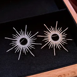 Vintage sunburst brooches in gold and silver plating with white zircon accents