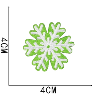 Detail view of snowflake embroidery patch in green and white measuring 4cm by 4cm