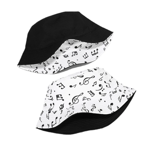 Reversible bucket hat with musical note print and minimalist solid black cotton fabric