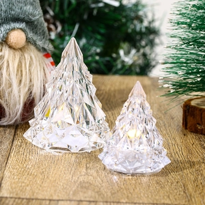 Luminous crystal faceted Christmas tree night lights on wood table for holiday decor