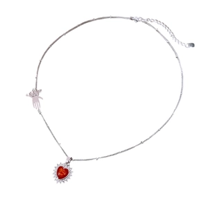 Vintage heart necklace with red zircon pendant and silver chain in minimalist style