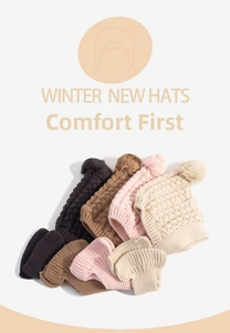 Detailed flat lay of knitted winter earflap hats with pom-poms in four neutral colors