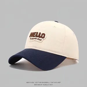 Close-up of HELLO embroidery on cotton color-block baseball cap with navy blue brim
