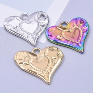 Detailed view of heart pendants in silver gold and rainbow colors with textured finish