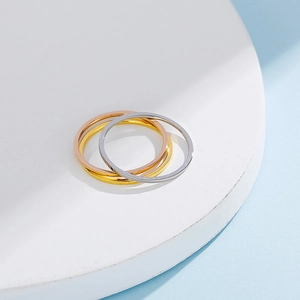 Three-tone minimalist stainless steel stackable rings in gold, silver, and rose gold