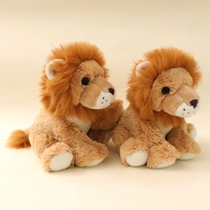 Cute plush lion stuffed animals with fluffy brown manes sitting in a warm studio setting
