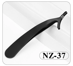 Macro shot of NZ-37 black stainless steel eyelash applicator tool on a white surface