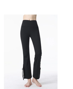 Detail of high waisted yoga flare pants with side slit and stylish bow tie decoration