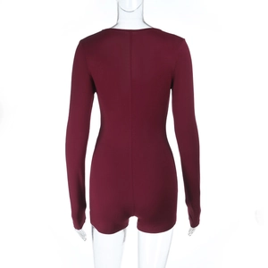 Detail view of burgundy slim fit long-sleeved jumpsuit with back seam and knit texture