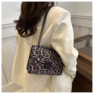 Leopard print small square bag worn with cream corduroy blazer over a chain strap