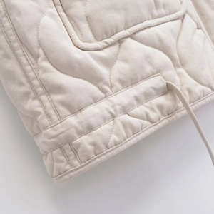 Quilted white vest featuring adjustable drawstring hem and detailed stitching