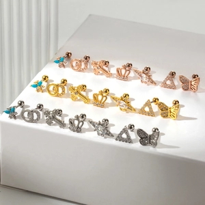 Detailed display of 21 zircon cartilage studs in gold, silver and rose gold finishes
