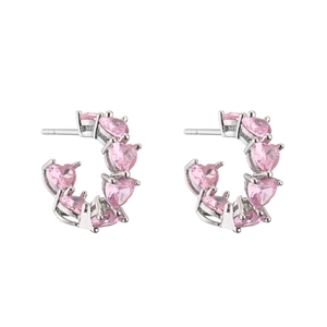 Detail of silver C-shaped hoop earrings featuring six claw-set pink heart cubic zirconia