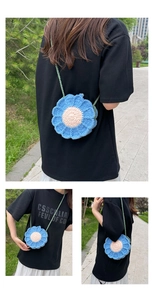 Detail of handmade crochet flower crossbody bag in sky blue and pink with green strap