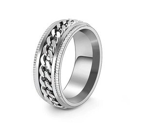 Close-up of a silver stainless steel spinner ring with an inlaid curb chain design