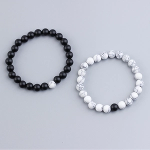 Detailed close-up of 8mm lava rock and white turquoise couple distance bracelets