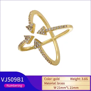 Crossed arrow gold ring with sparkling crystals and brass finish for women