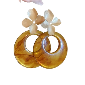 Elegant gold flower and brown acrylic resin drop earrings on white background