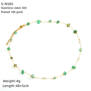 Detail of 18k gold plated stainless steel necklace with green turquoise stones and specs