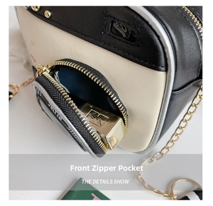 Detail view of the front zipper pocket on a color-block crossbody bag showing storage space