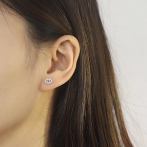 Close-up of S925 silver evil eye stud earring with blue crystal and pavé diamonds