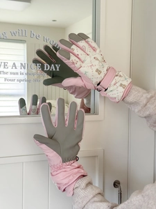Detail of pink quilted ski gloves showing palm grip and cute teddy bear prints