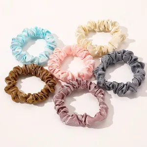 Set of six satin silk scrunchies in pastel colors with smooth pleated texture detail