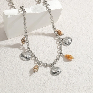 Silver stainless steel seashell necklace with natural conch pendant on a white stone
