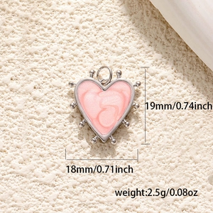 Detail of 18K gold-plated heart pendant with pink enamel swirl and dimension markings
